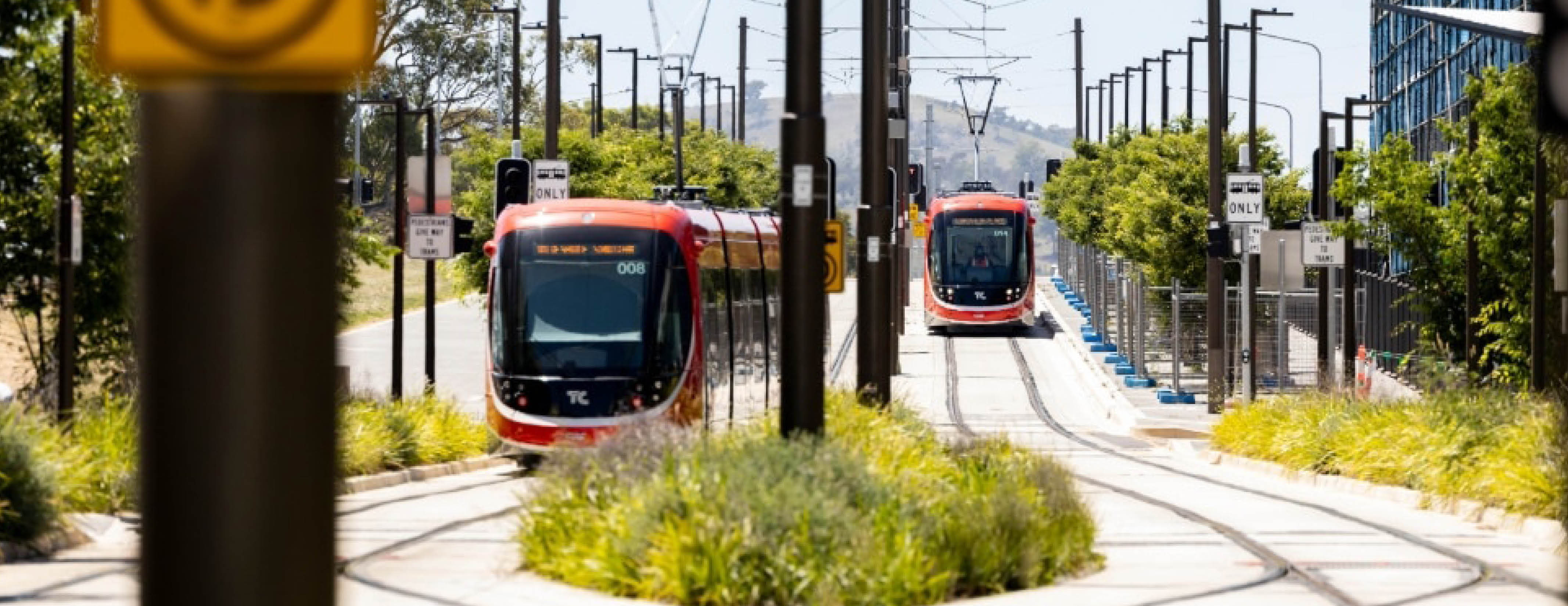 Two light rail vehicles crossing paths in Gungahlin ACT