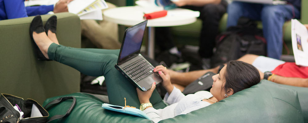 Students sit on couches and beanbags to study in an ANU library.