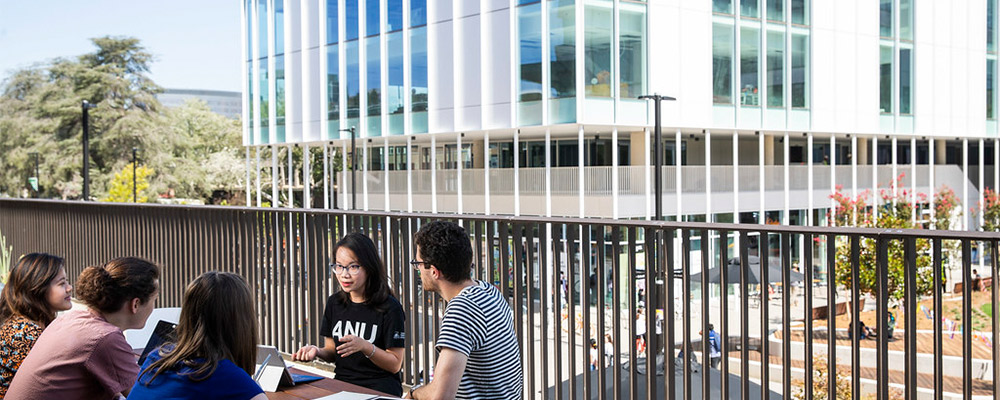 Students study together on a table overlooking the Kambri social hub.