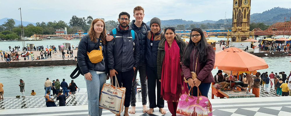 Ketan and his family stand with Campbell and his girlfriend in India.