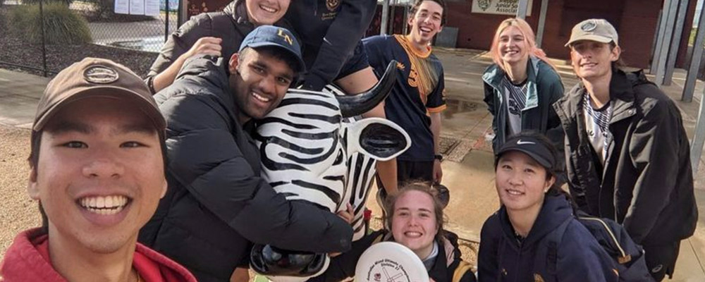 Ashy hangs out with the iconic painted cows in Shepparton,
            Victoria, with a group of ANU students in.