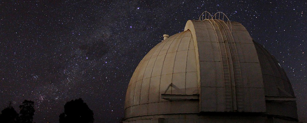 Mt Stromlo Observatory under a starry night sky
