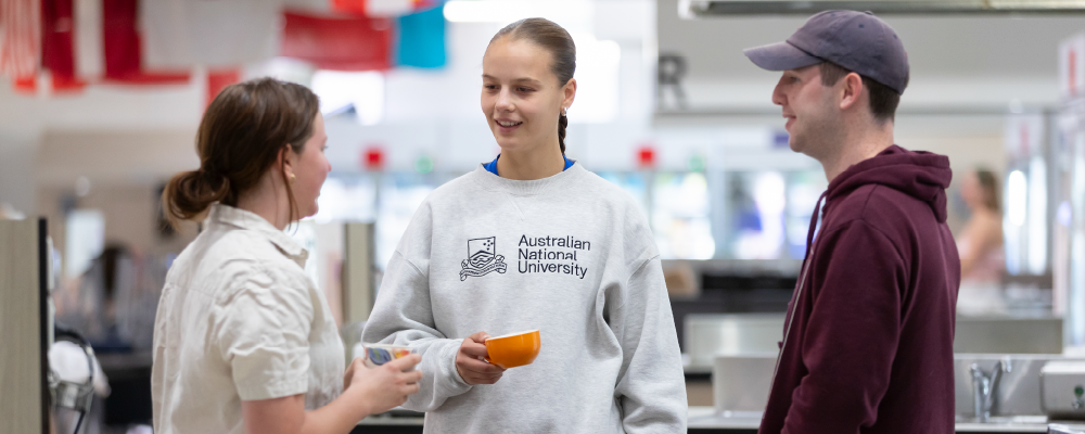 Students chatting in an ANU residence kitchen.