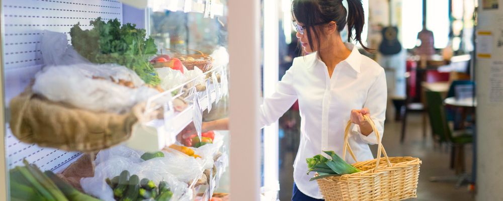 ANU student shopping for fresh vegetables at the Food Co-op on campus