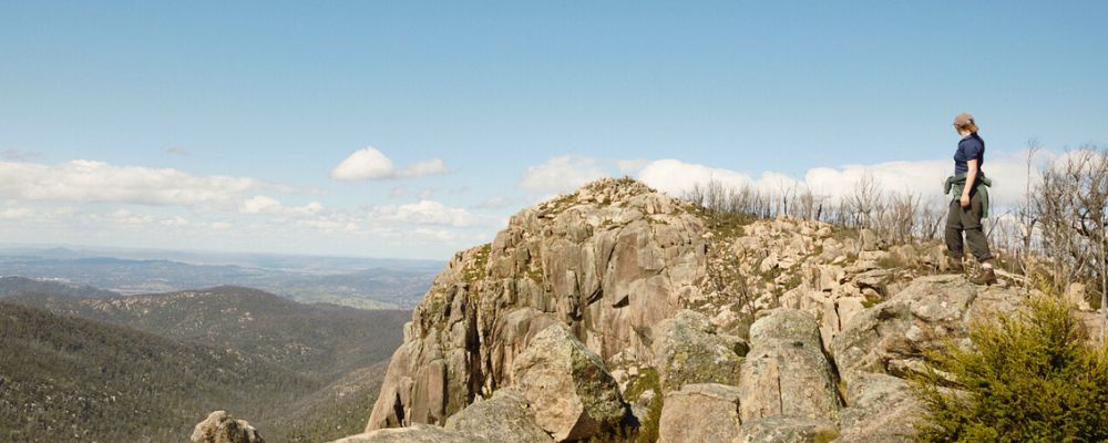 Female ANU student hiking in Canberra at Booroomba Rocks