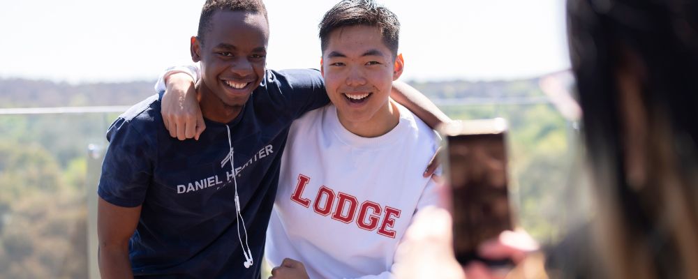Two ANU students living on campus having fun and posing for a photo at a student residence.