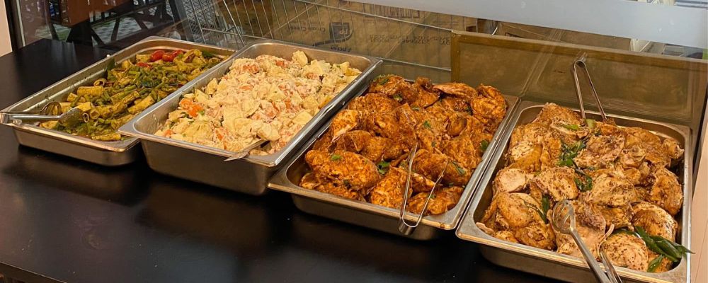 Three platters of food within the Brian Kenyon Student Space (BKSS) at ANU