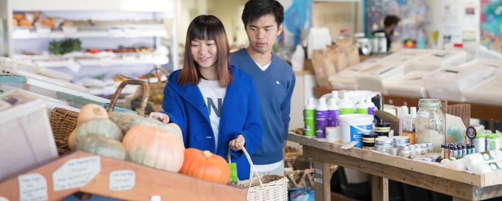 Two ANU students shop together at the Food Co-Op in Canberra.