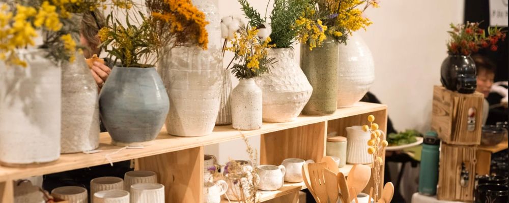 A shelf demonstrating different ceramic pots at Canberra Potters.