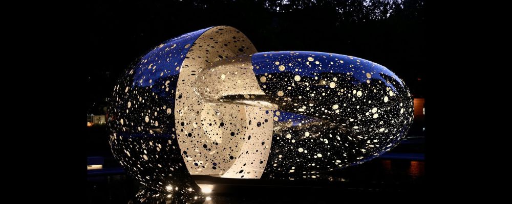 The Ouroboros sculpture by artist Lindy Lee photographed by night at the National Gallery of Australia