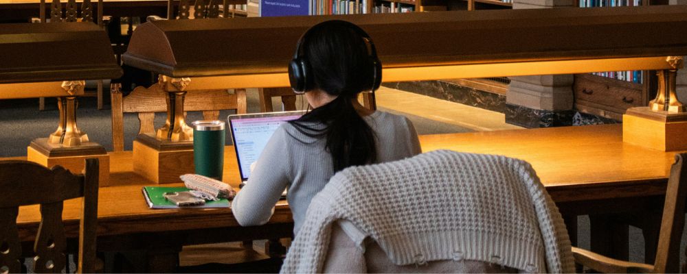 A female student studying in a library institution