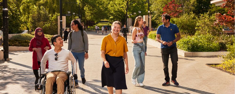 Australian National University students walk in the sunshine down University Avenue.