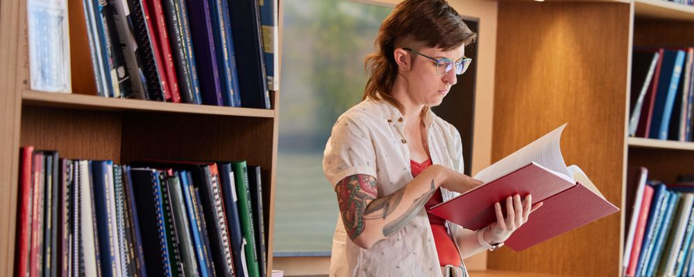 An ANU student reading in the ANU Research School of Social Sciences library.