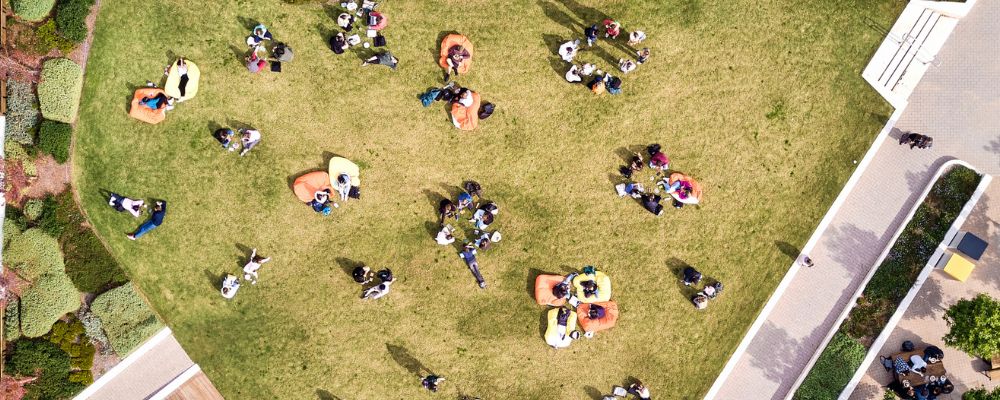 A birds-eye overhead shot of Kambri lawns with ANU students sitting on beanbags.