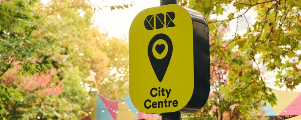 A scene on City Walk in the Canberra CBD. The CBR logo on a signpost.