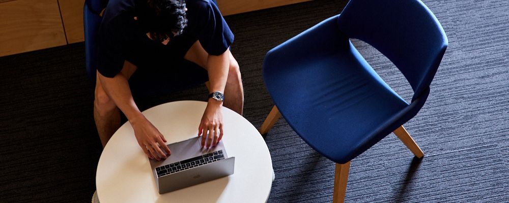 An ANU postgraduate student studies on a laptop in the Marie Reay Teaching Centre.