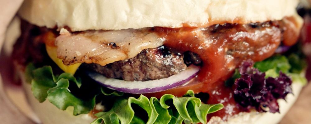 A zoomed in view of the inside fillings of a burger from Brodburger in Canberra.